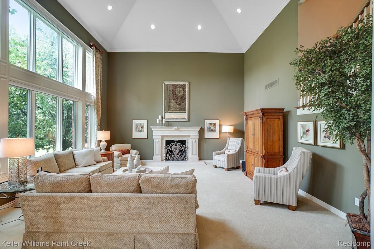 4902 Crestone Way Rochester, MI 48306 - Photo 35 of 70 An Impressively sized (20x20), two story Family Room with incredible cathedral ceilings and stone Fireplace.