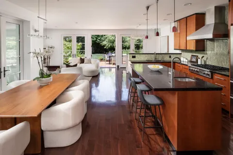 a dining room with furniture a rug and wooden floor