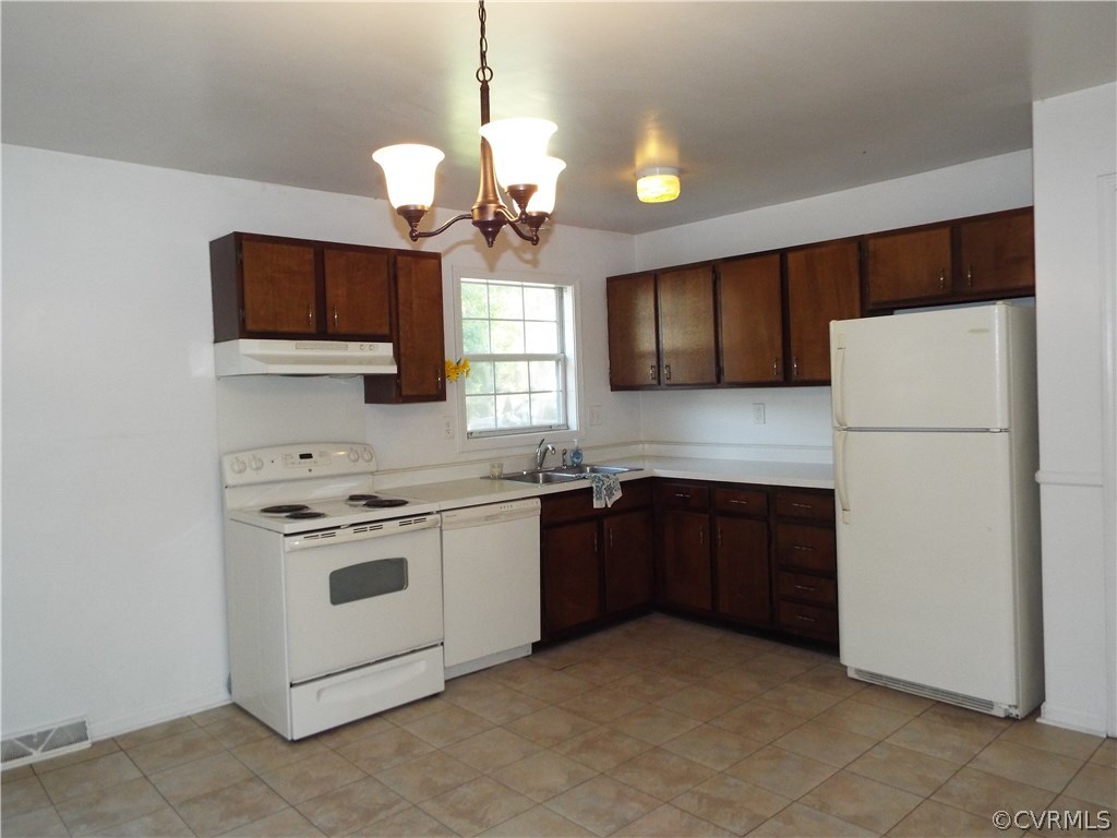 6009 Barrister Road Chesterfield, VA 23832 - Photo 4 of 8 a kitchen with a stove a sink and a refrigerator