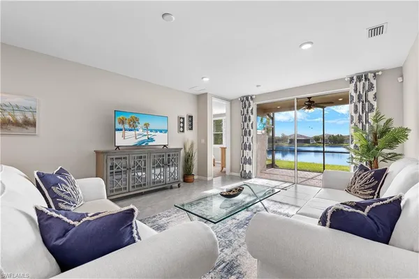 a living room with furniture and a floor to ceiling window