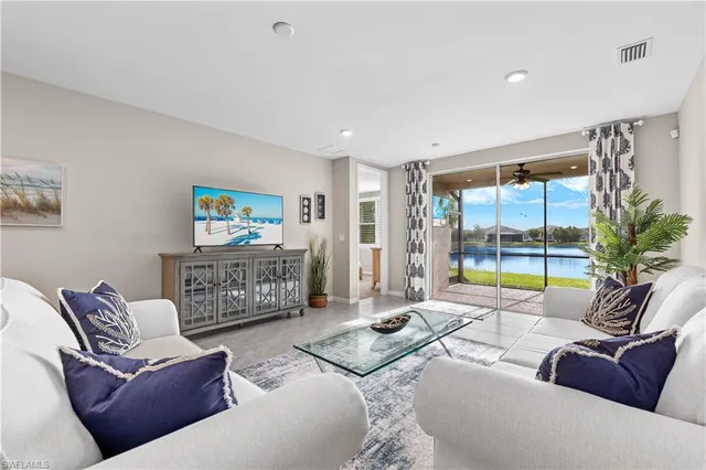 a living room with furniture and a floor to ceiling window