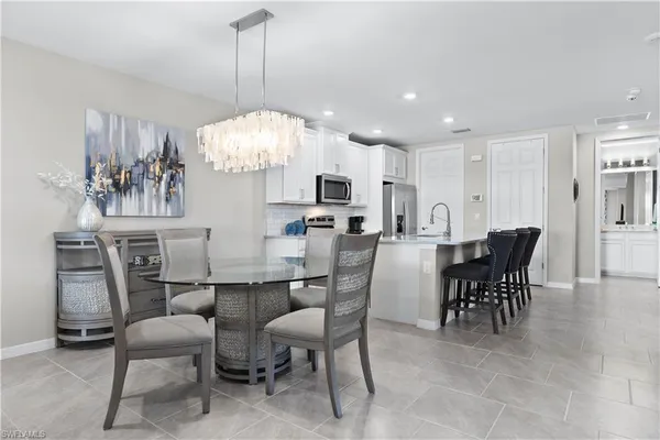 a view of a dining room with furniture and chandelier
