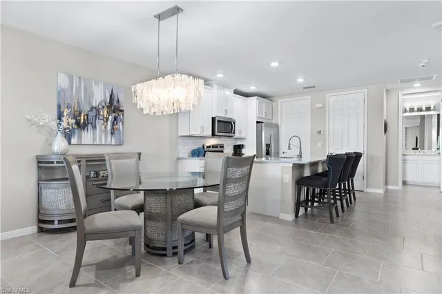 a view of a dining room with furniture and chandelier