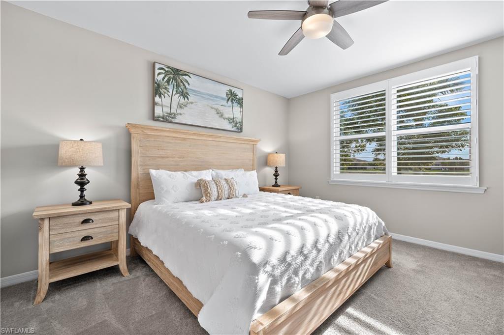 14558 Edgewater Circle Naples, FL 34114 - Photo 12 of 33 a bedroom with a bed and a window