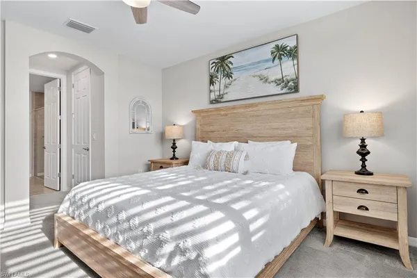 a bedroom with a bed and a lamp