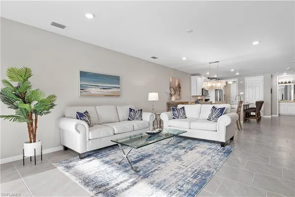 a living room with furniture potted plant and a lamp