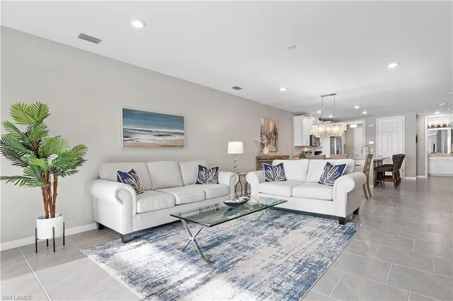 a living room with furniture potted plant and a lamp