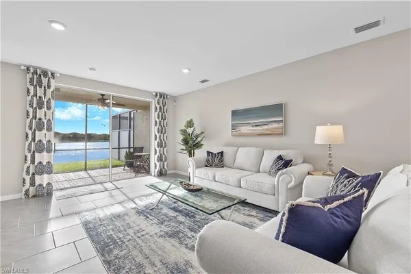 a living room with furniture and a large window