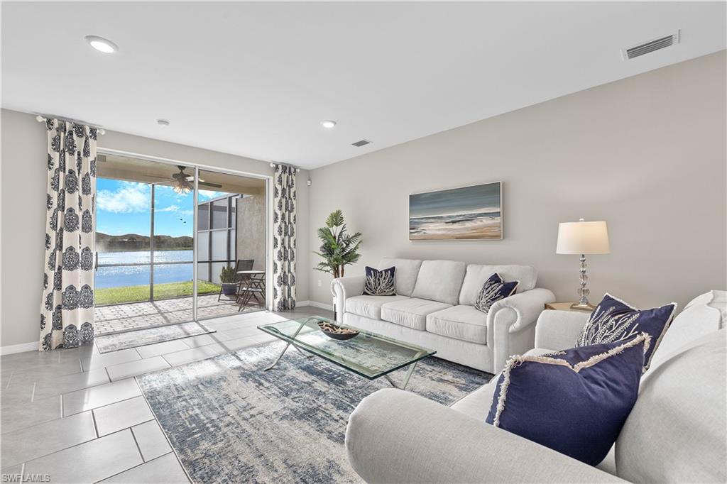 14558 Edgewater Circle Naples, FL 34114 - Photo 4 of 33 a living room with furniture and a large window