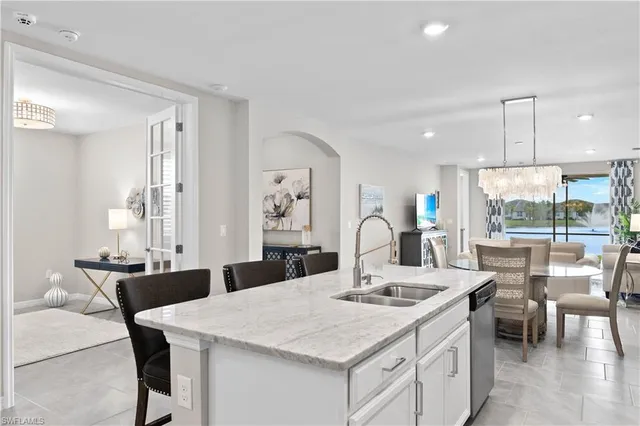 a kitchen with a table chairs and white cabinets