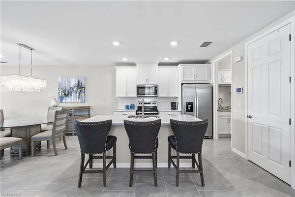 a kitchen with refrigerator and table