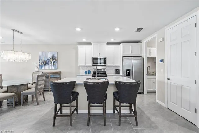 a kitchen with refrigerator and table