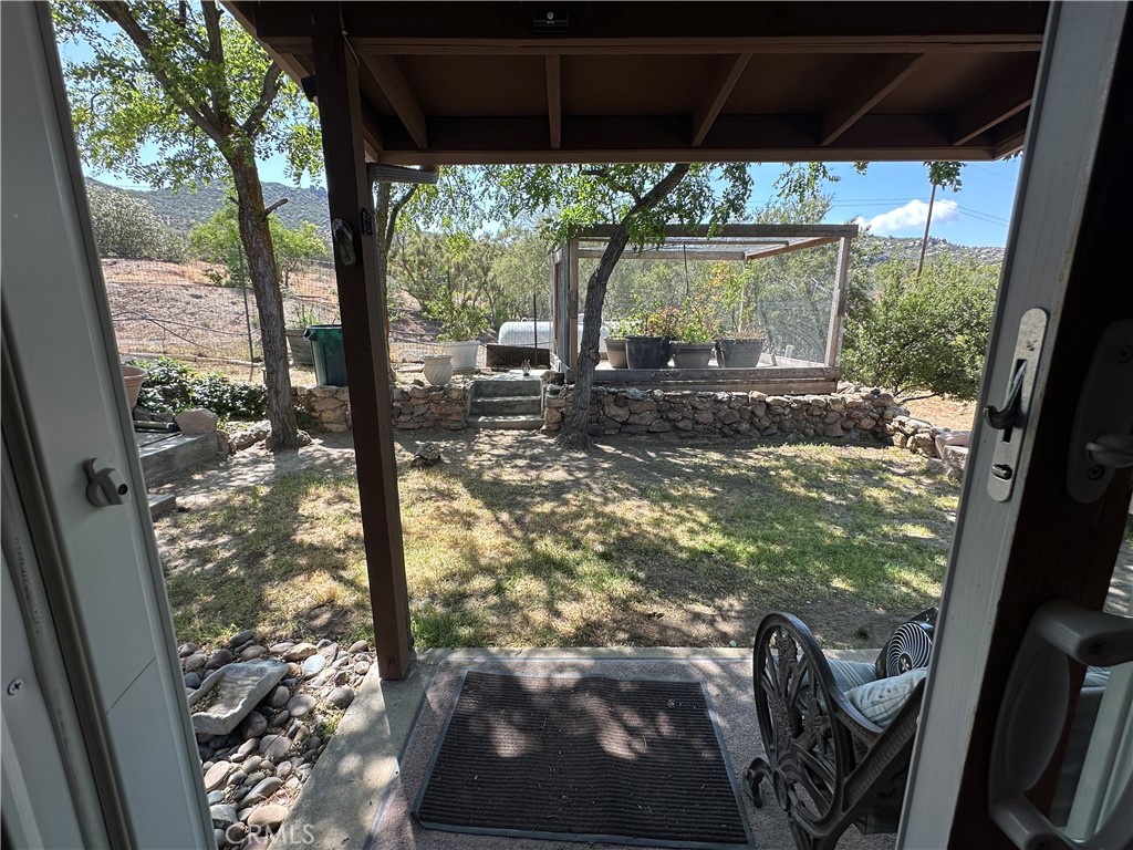 57260 Ramsey Road Anza, CA 92539 - Photo 33 of 46 a view of a porch with wooden floor and outdoor seating
