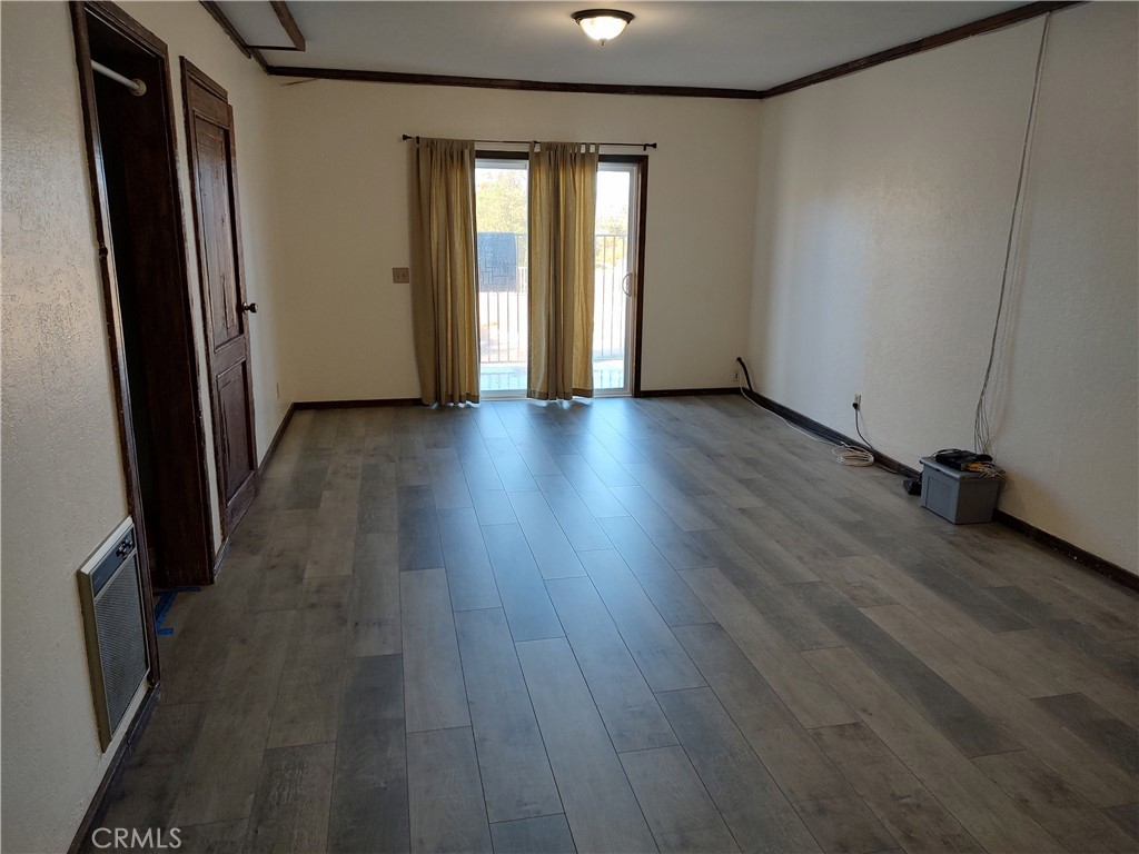 57260 Ramsey Road Anza, CA 92539 - Photo 45 of 46 an empty room with wooden floor and windows