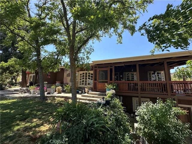 a front view of a house with garden and patio