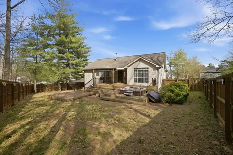 a view of a house with backyard sitting area and garden