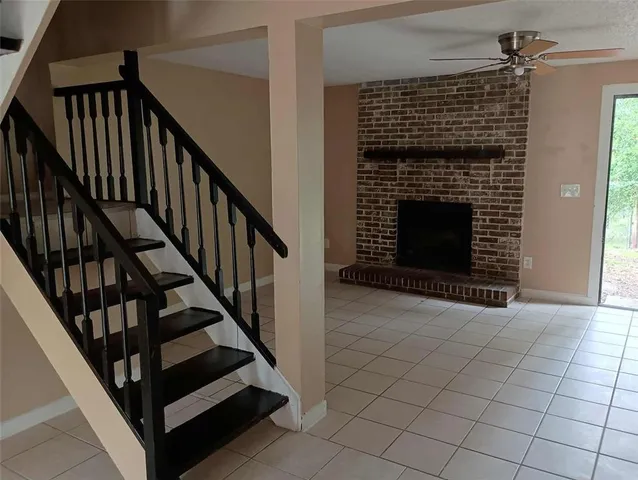 a view of hall way with wooden floor and a fireplace