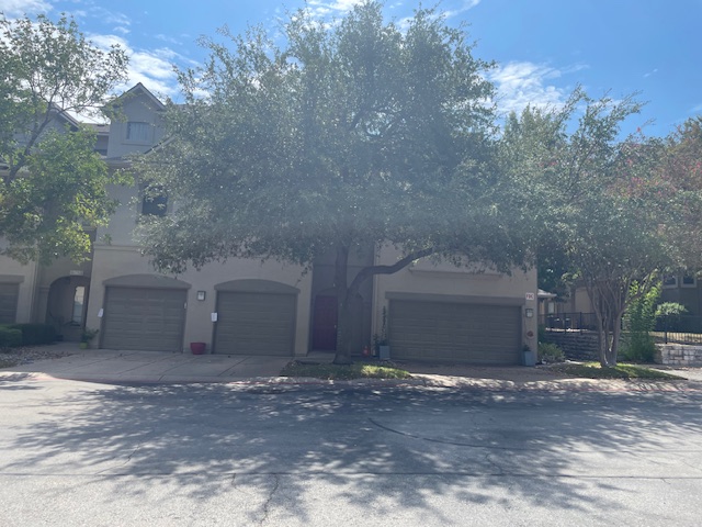 11203 Ranch Road 2222, Unit 703 Austin, TX 78732 - Photo 1 of 8 Mature trees frame the exterior of this multi-level home with integrated multi-car garage storage.