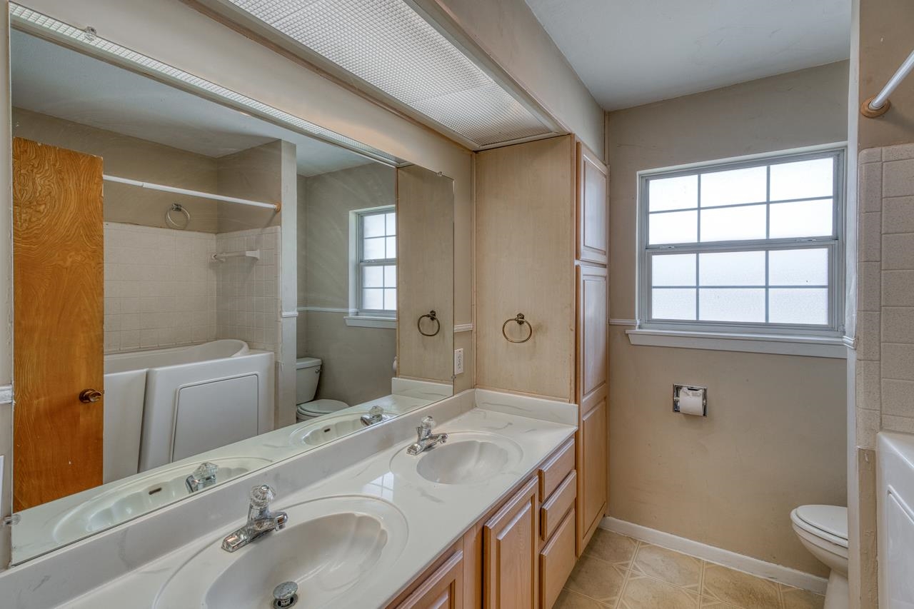 111 Dove Road Highland Haven, TX 78654 - Photo 14 of 19 a bathroom with a sink and a mirror