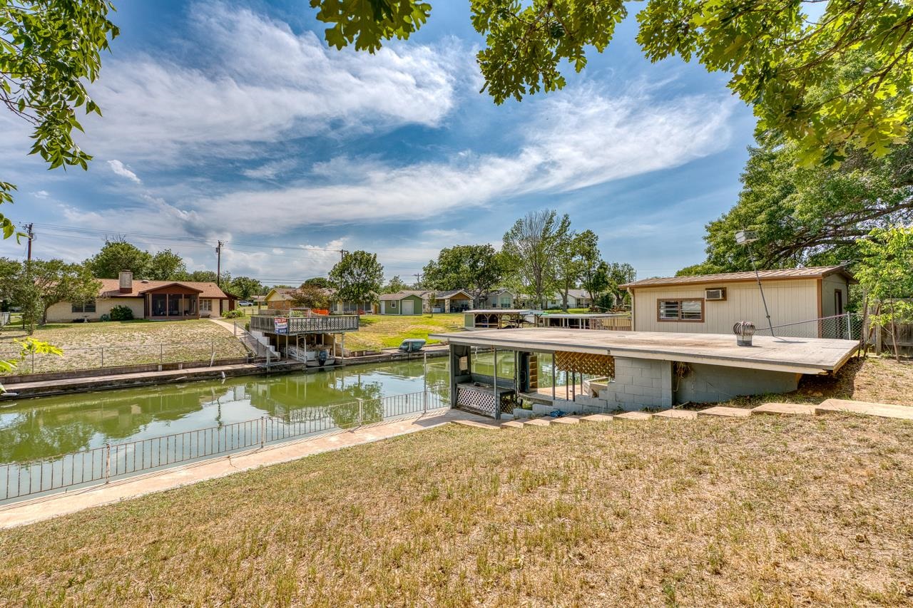 111 Dove Road Highland Haven, TX 78654 - Photo 2 of 19 a view of house with outdoor space and swimming pool