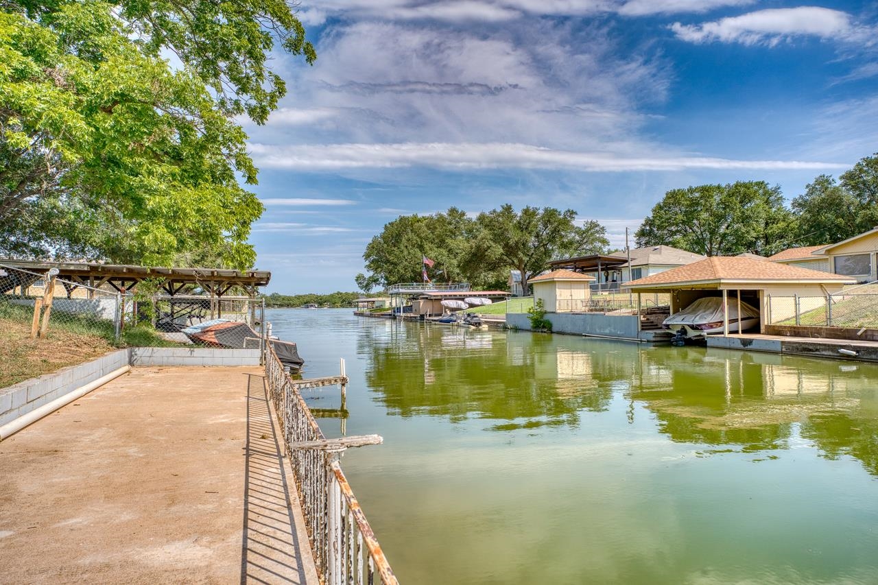 111 Dove Road Highland Haven, TX 78654 - Photo 8 of 19 a view of a lake with a house in the background
