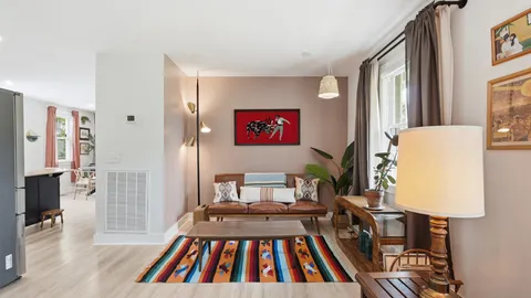 a view of a bedroom with furniture window and wooden floor