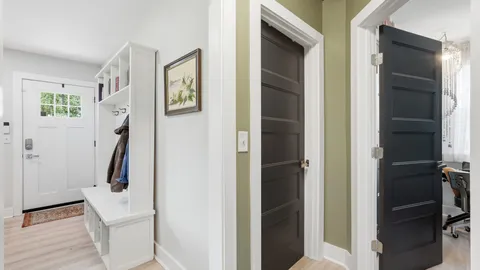 a view of hallway with stairs and wooden floor