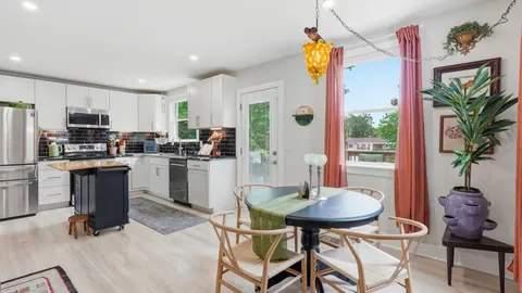 a kitchen with a table and chairs in it