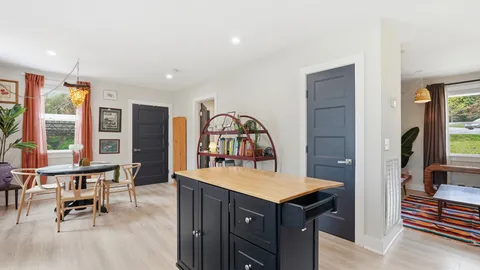 a dining room with furniture and a floor to ceiling window