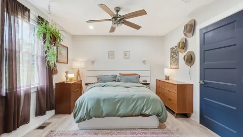a bedroom with a bed and a mirror