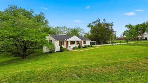 a front view of a house with a garden