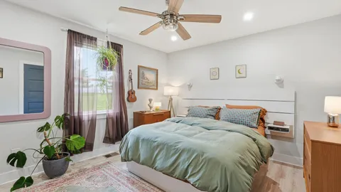 a bedroom with double bed and a potted plant