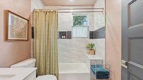a bathroom with a bathtub and shower