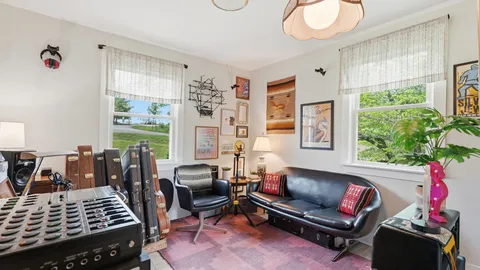 a living room with furniture fireplace and window