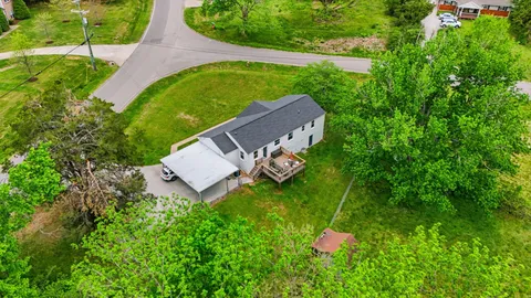an aerial view of a house with a yard
