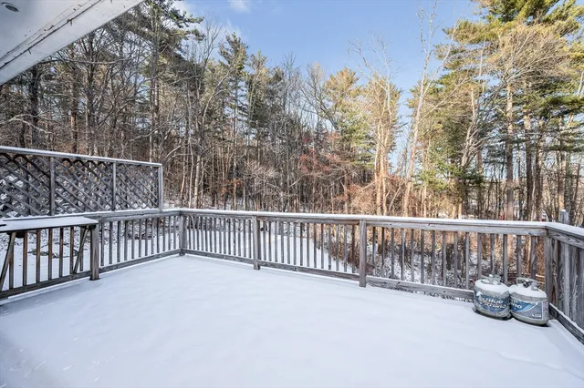 a view of balcony with wooden floor and fence
