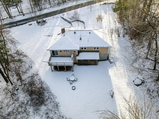 an aerial view of a house with a yard