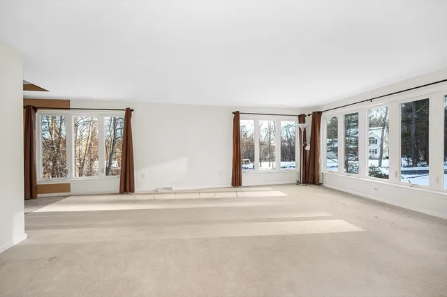 a living room with a large window and front door