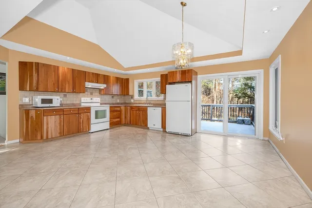 a large kitchen with cabinets and stainless steel appliances