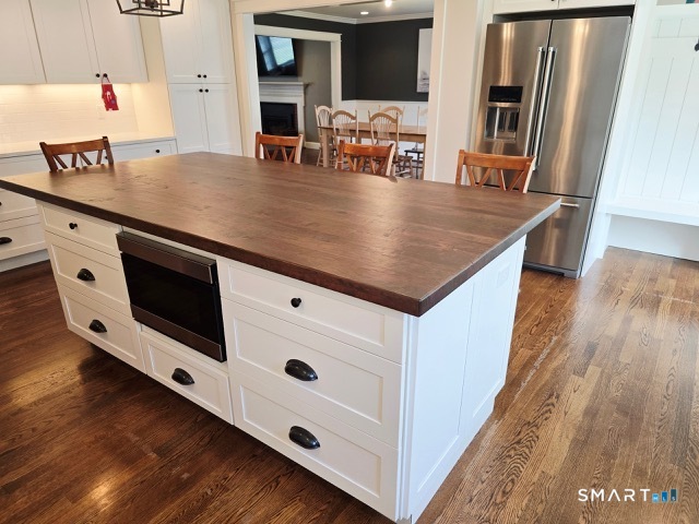 441 David Court Orange, CT 06477 - Photo 12 of 24 an open kitchen with a sink and refrigerator