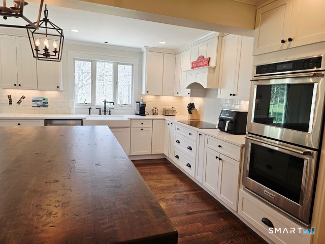441 David Court Orange, CT 06477 - Photo 13 of 24 a kitchen with granite countertop a sink stainless steel appliances and cabinets