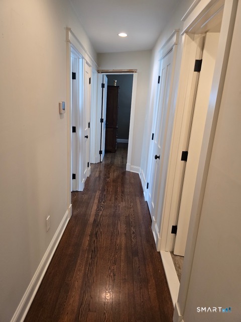 441 David Court Orange, CT 06477 - Photo 17 of 24 a view of a hallway with wooden floor and staircase
