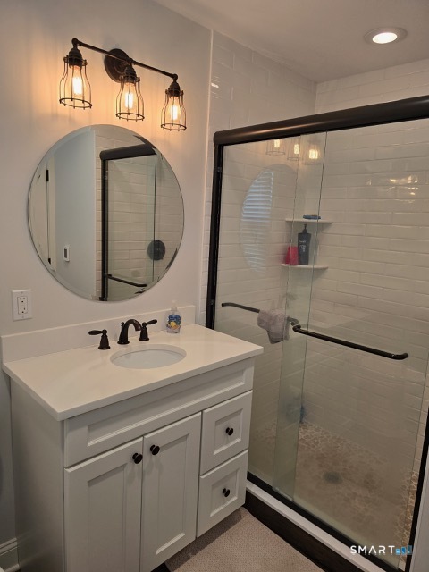 441 David Court Orange, CT 06477 - Photo 18 of 24 a bathroom with a sink and a mirror