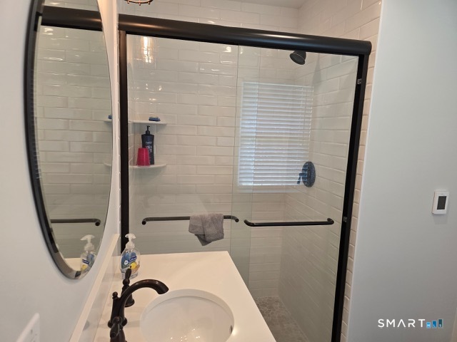 441 David Court Orange, CT 06477 - Photo 19 of 24 a bathroom with a sink and a mirror
