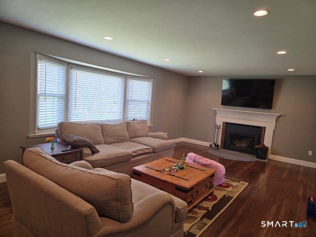 441 David Court Orange, CT 06477 - Photo 6 of 24 a living room with furniture a flat screen tv and a fireplace