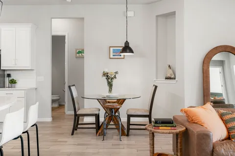 a dining room with furniture and wooden floor