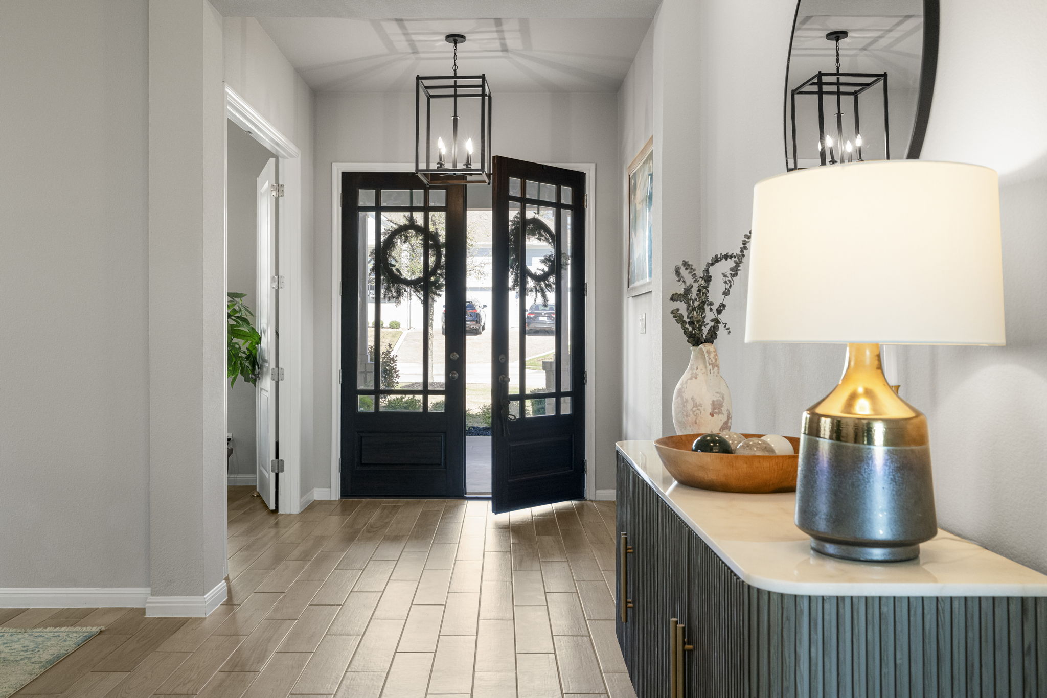 546 Hazy Hills Loop Dripping Springs, TX 78620 - Photo 2 of 40 The grand double-door entry opens to a bright and airy foyer, setting the tone for the home’s thoughtful design.