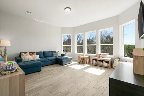 a living room with furniture and a large window