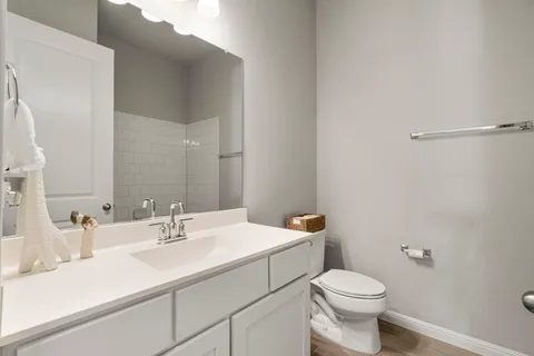 a bathroom with a sink toilet and vanity