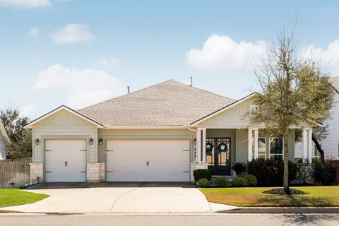 front view of a house with potted plants